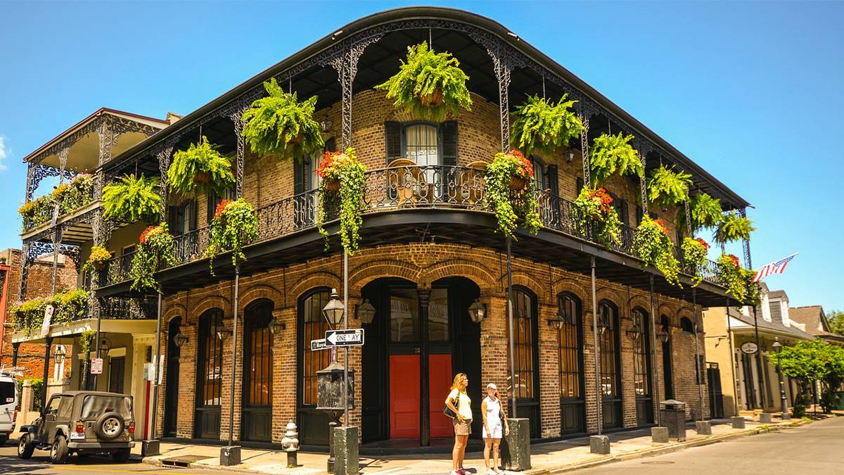 Two tourists on the street in the French Quarter of Nola in New Orleans, Louisiana, USA