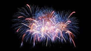 Red and white fireworks over a dark sky